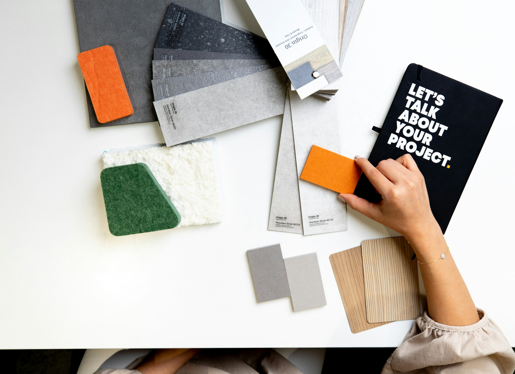 Interior designer choosing material and fabric samples for a project consultation